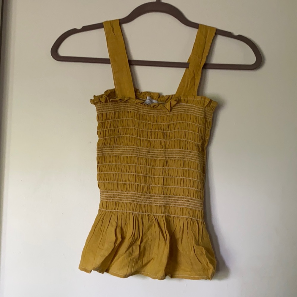 Mustard yellow tank top with white stitching